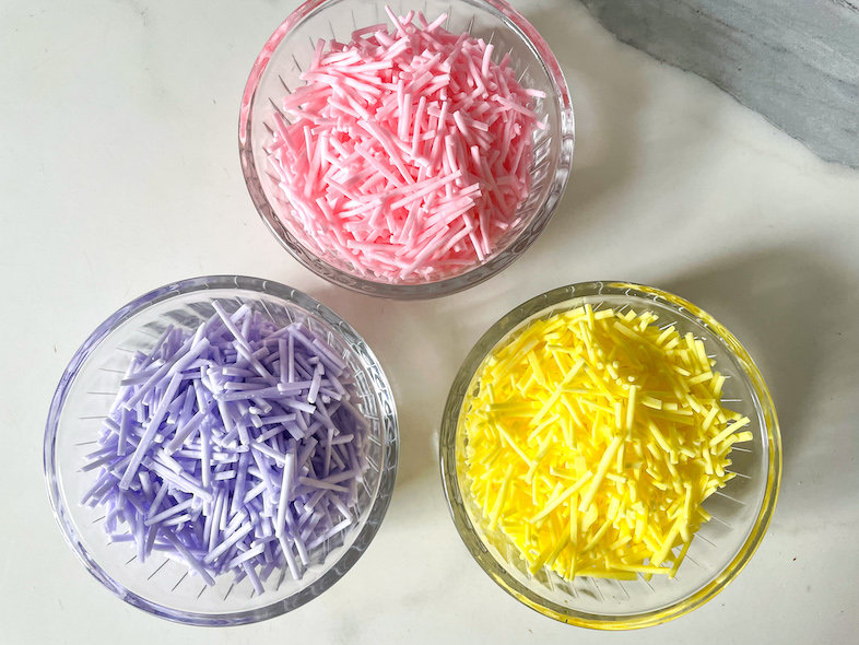Bowls of pink, yellow and purple homemade sprinkles