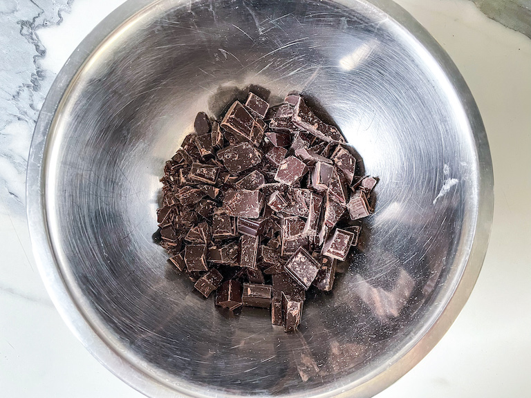 A bowl of chopped dark chocolate