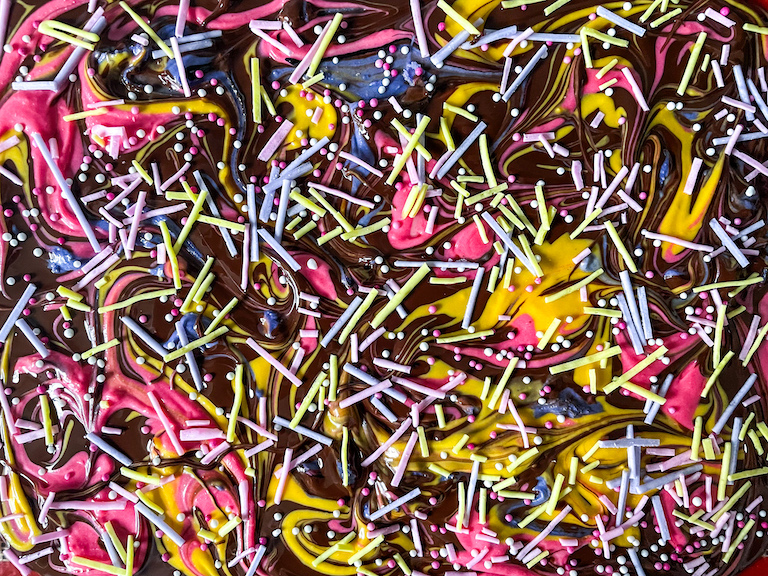 Multicolored chocolate topped with sprinkles