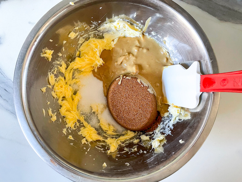 Butter, sugar, and tahini in a mixing bowl with a spatula