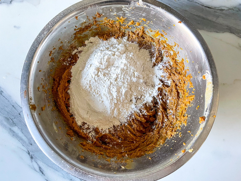 A bowl with ingredients for chocolate chip tahini cookies