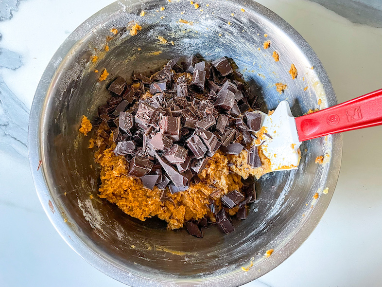 Adding chunks of chopped dark chocolate to tahini cookie batter