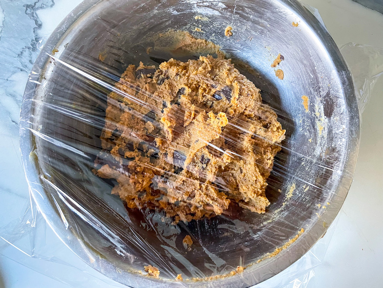 Bowl of dough for making chocolate chunk tahini cookies