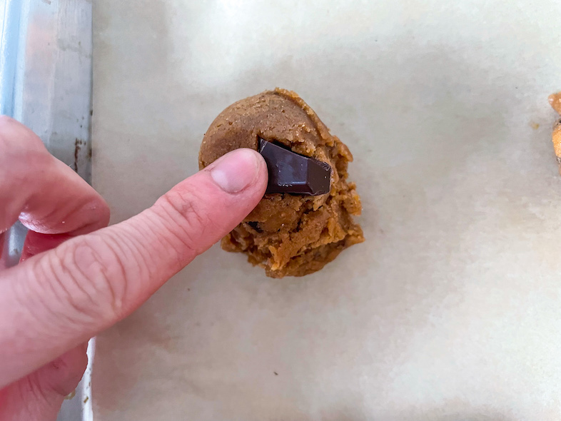 Adding chunks of chocolate to unbaked tahini cookies
