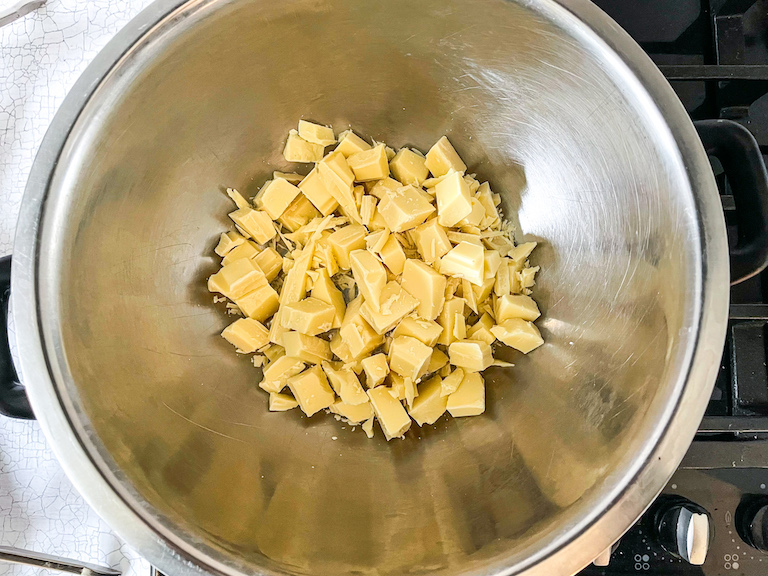 Chopped white chocolate in a metal bowl