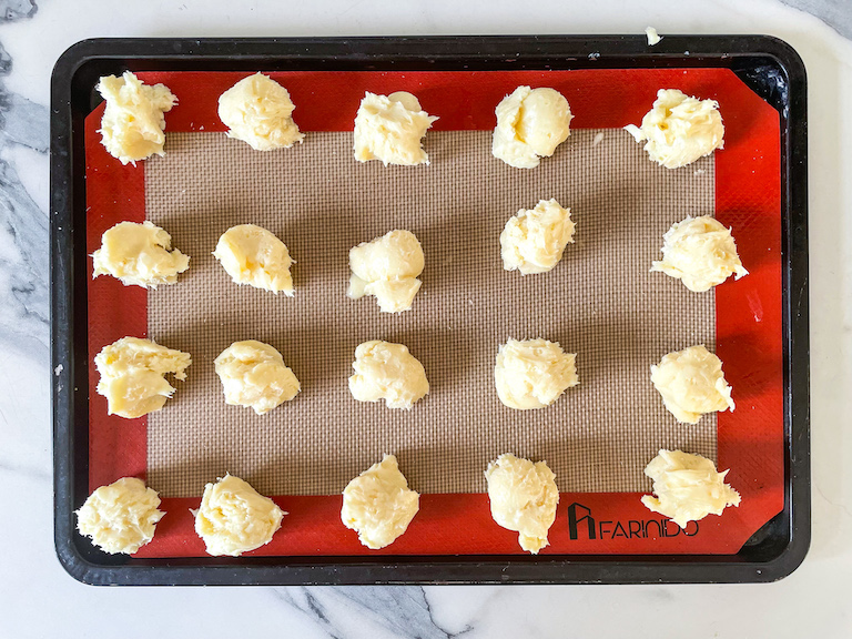 Scoops of white chocolate ganache on a tray