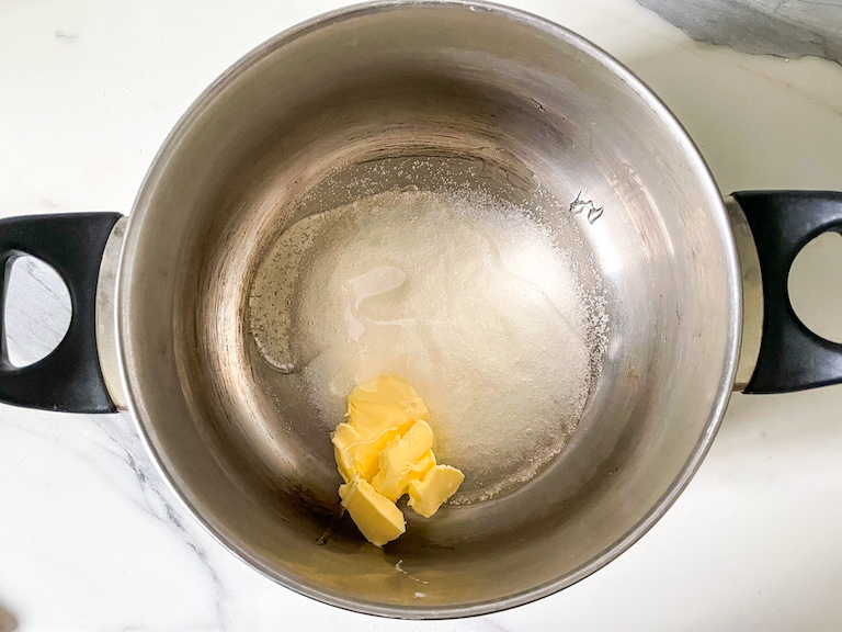A saucepan with butter, glucose syrup and sugar