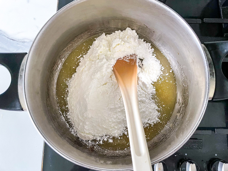 Stirring confectioner's sugar into hot syrup in a saucepan