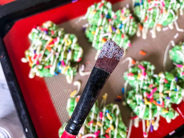 A paintbrush with edible silver glitter