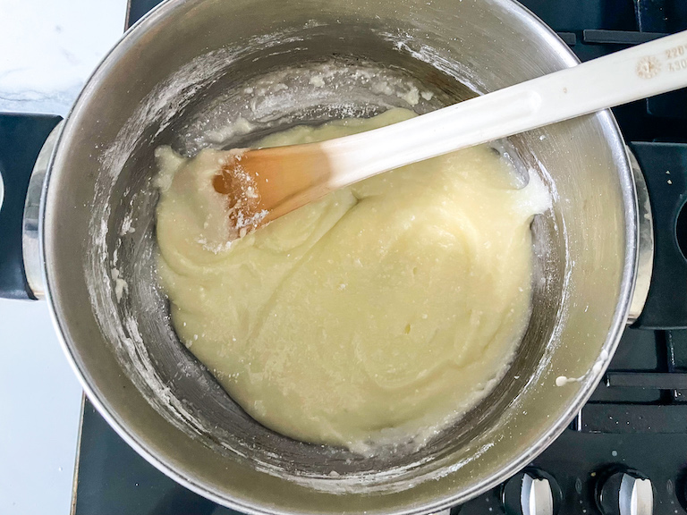 Candy corn batter in a saucepan with spoon
