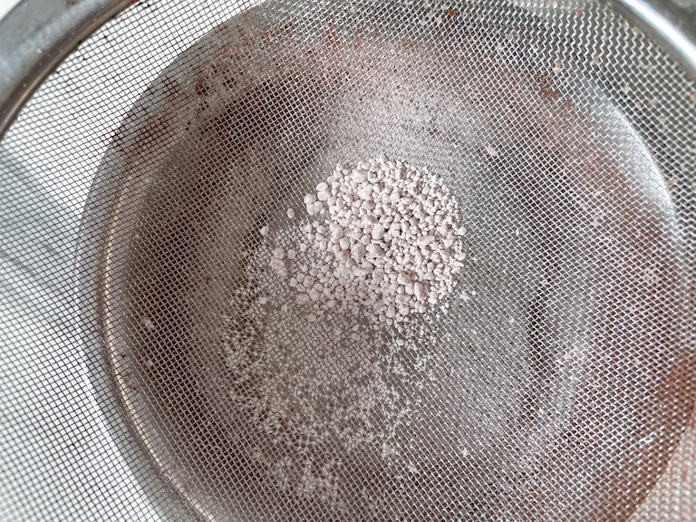 Sifting confectioner's sugar to remove lumps
