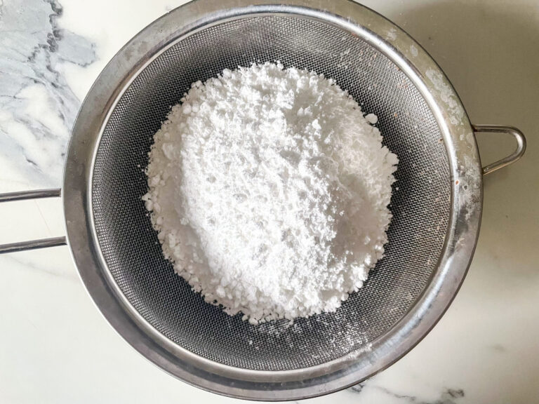 A mesh sieve with confectioner's sugar