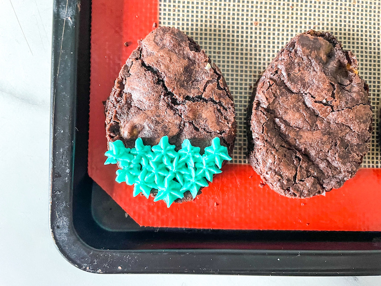 Decorating egg shaped Easter brownies