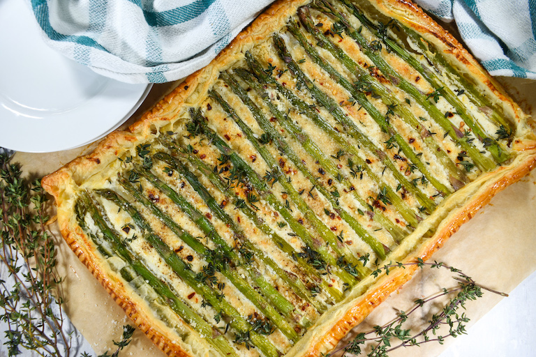 Rectangular shaped puff pastry tart with asparagus and goat cheese