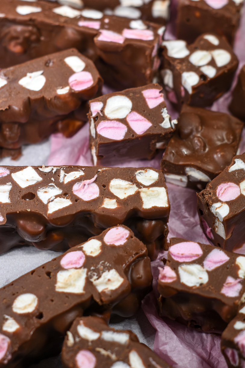 Squares of easy fudge with marshmallows, on a sheet of pink tissue