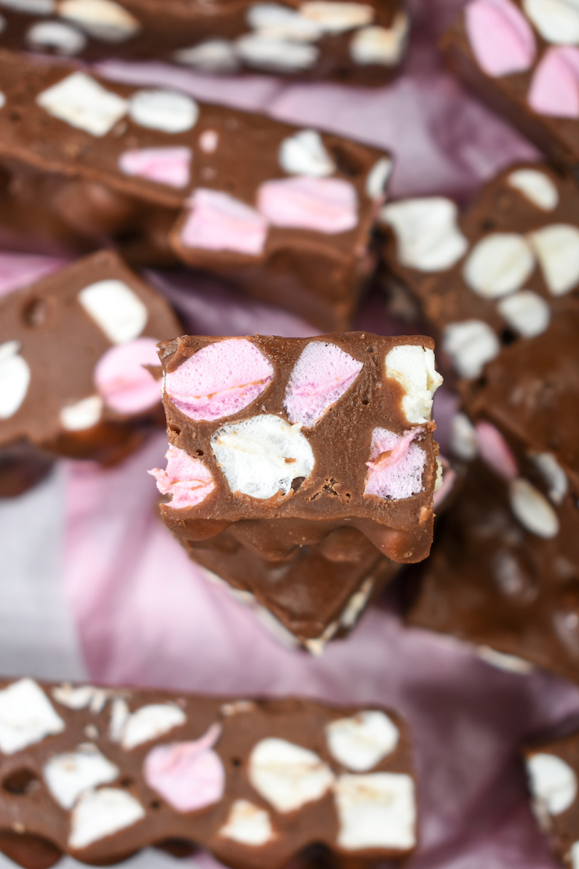 fudge with pink and white marshmallows on a pink surface
