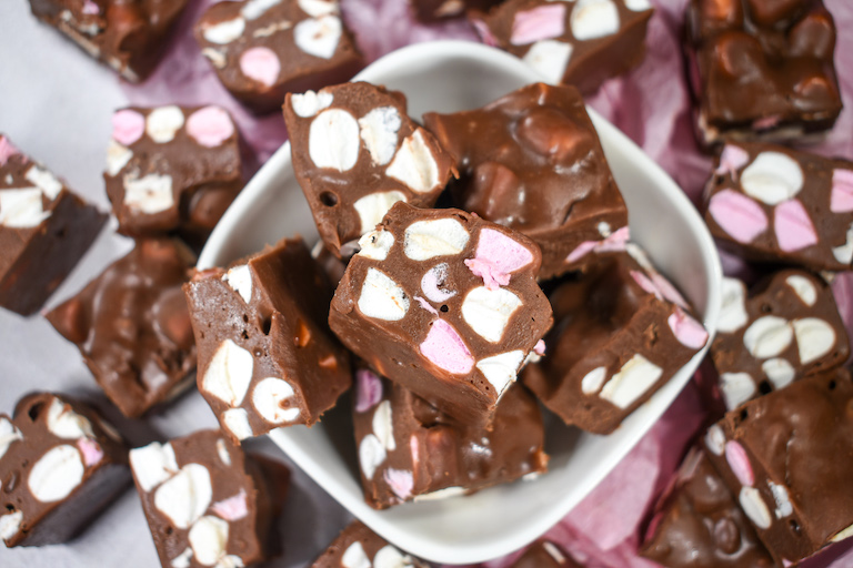 A bowl of fudge with pink and white marshmallows, in a small white bowl