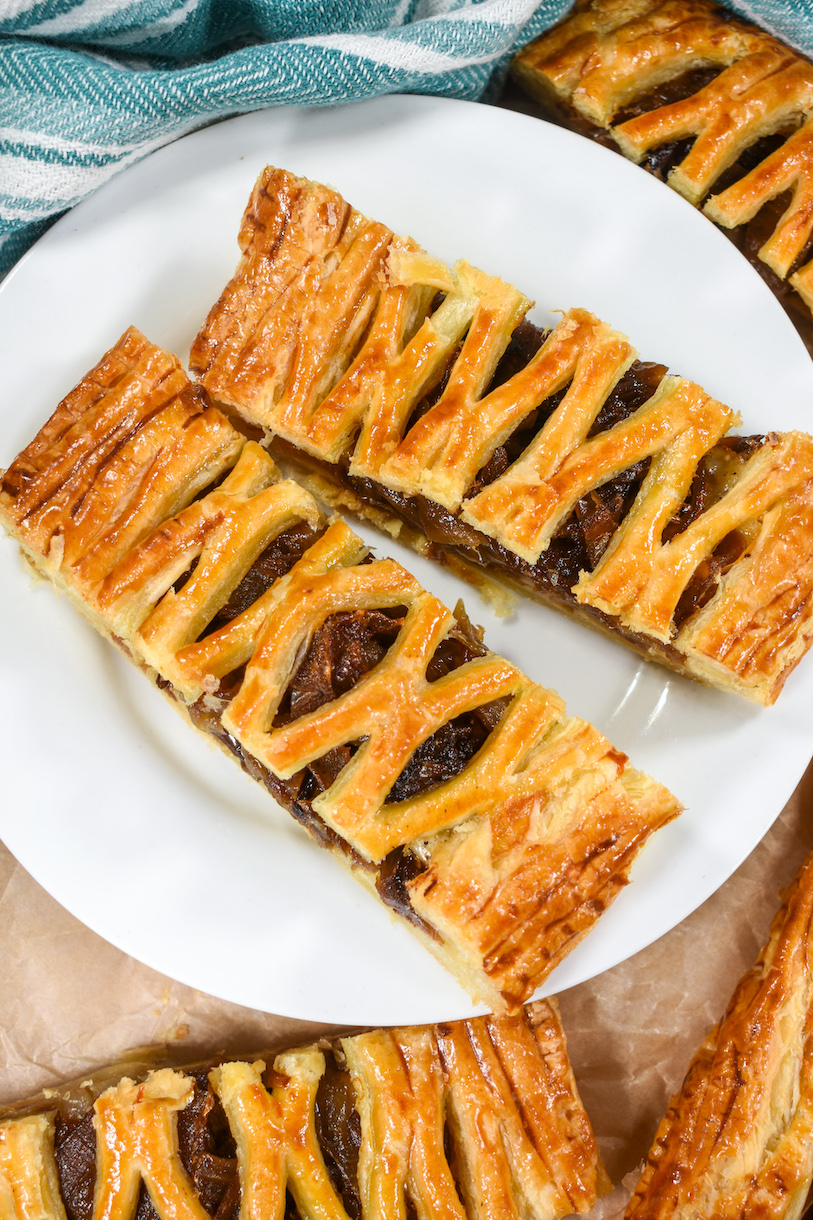 Two slices of caramelised onion puff pastry, cut with a lattice cutter