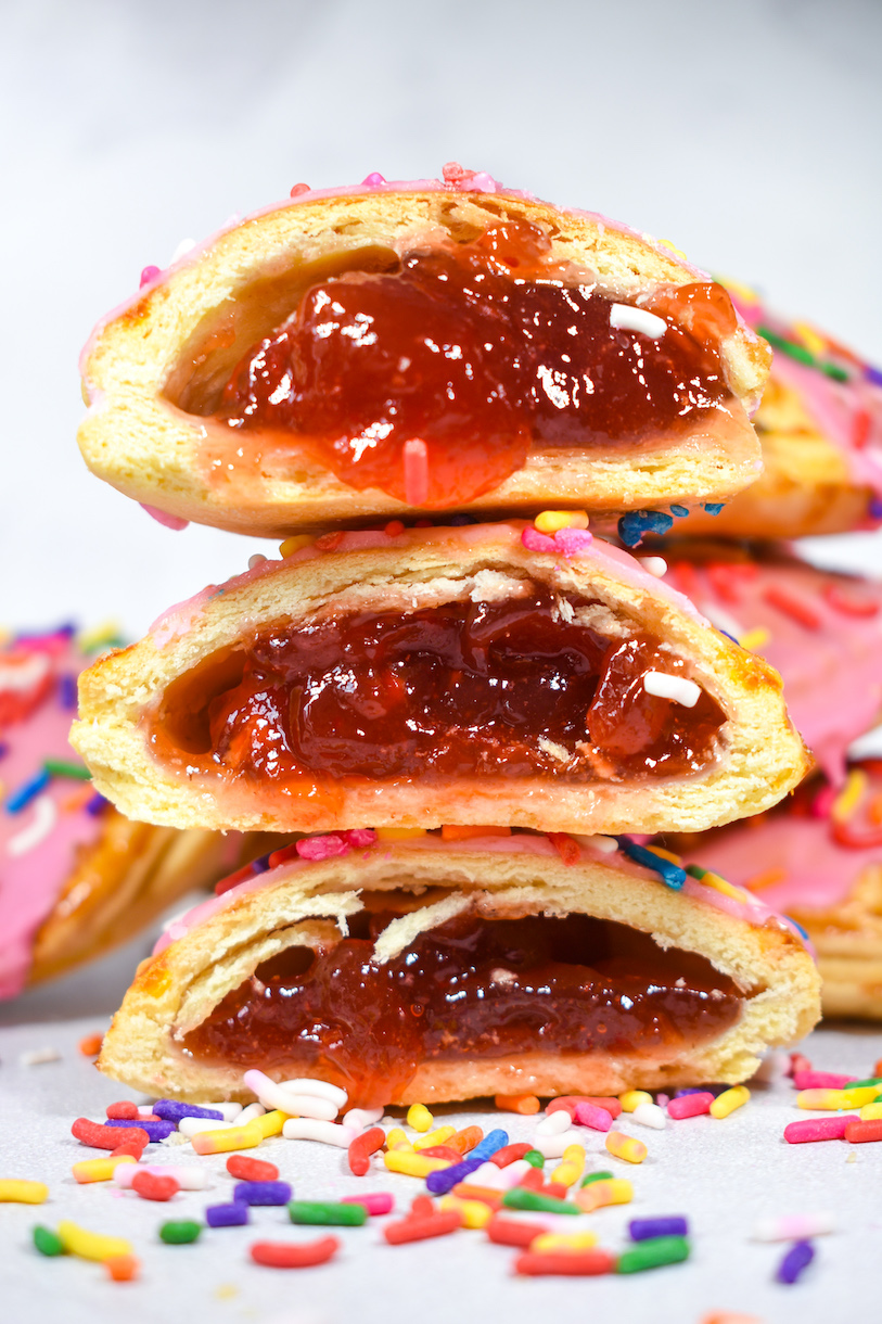 A stack of three strawberry hand pies with jam filling