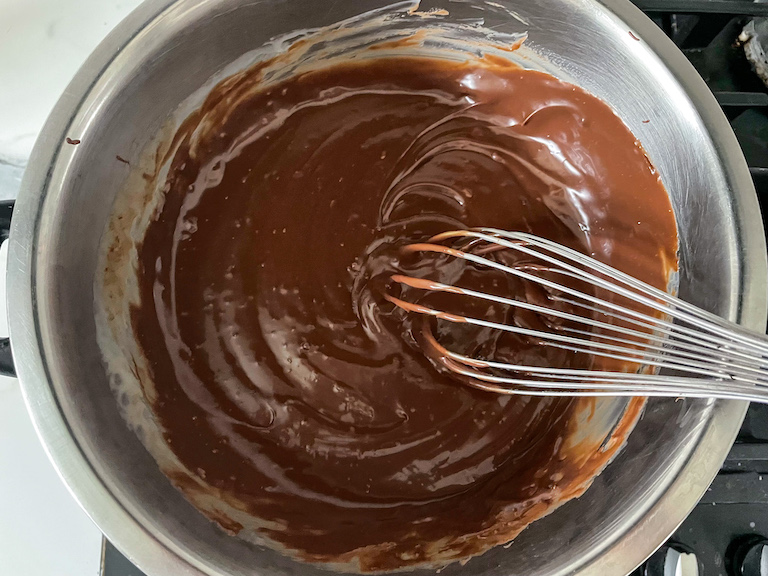 Three ingredient fudge mixture in bowl with whisk