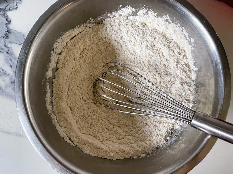 Dry ingredients in bowl with a whisk