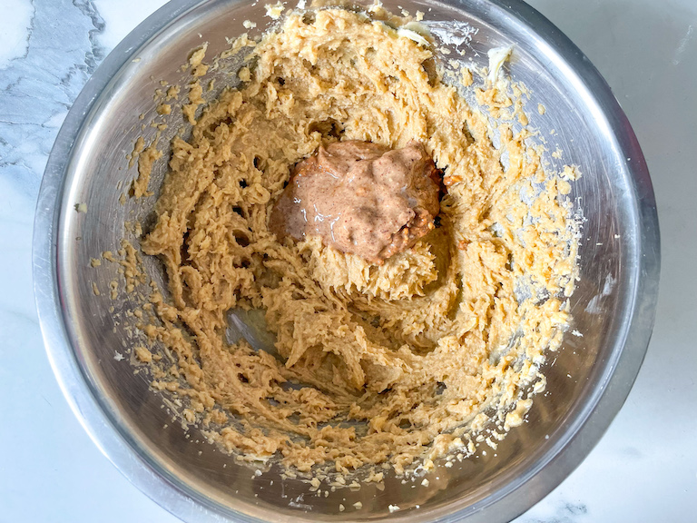 Almond butter added to bowl of blondie batter