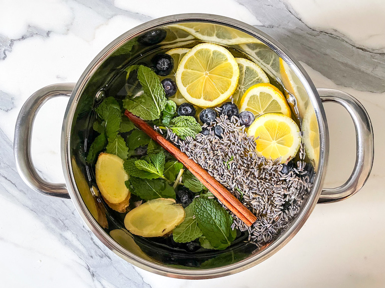 A metal stock pot filled with ingredients for a DIY simmer pot
