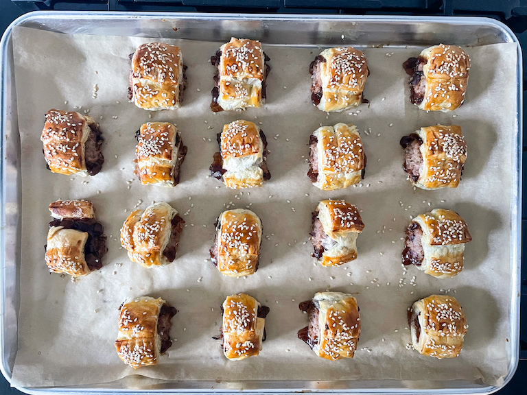 A tray of fresh baked sausage rolls