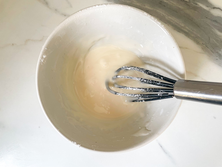 Whisk and glaze in a bowl
