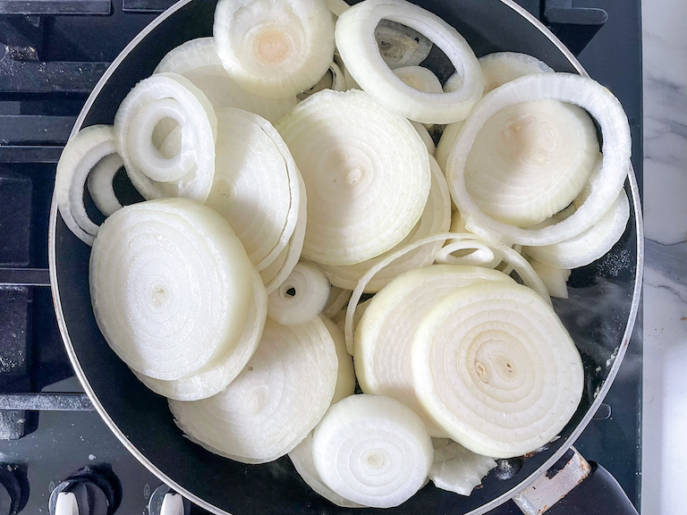 Rings of raw onion in a saucepan