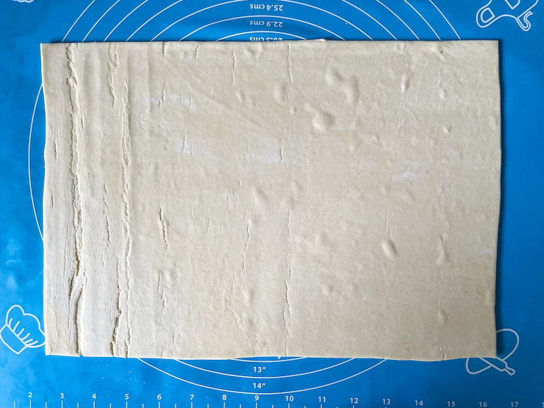 Sheet of puff pastry on a silicone rolling mat