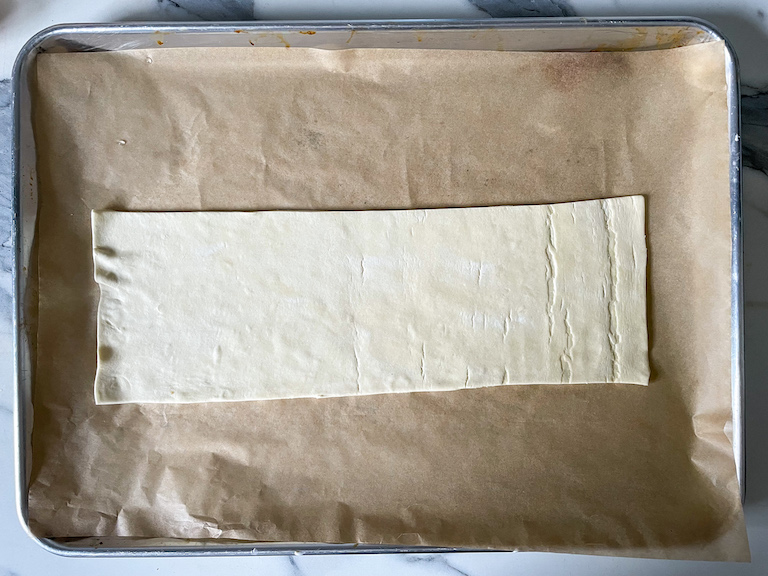 Puff pastry rectangle on a parchment lined tray