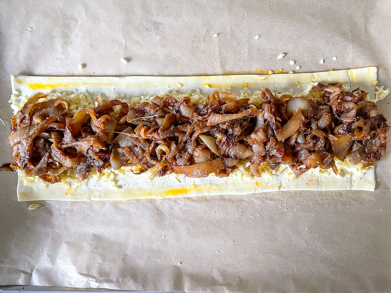 Puff pastry rectangle with cheese and caramelised onions