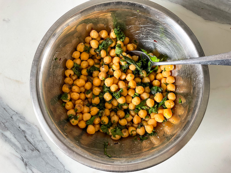 Chickpeas and herbs in a metal bowl