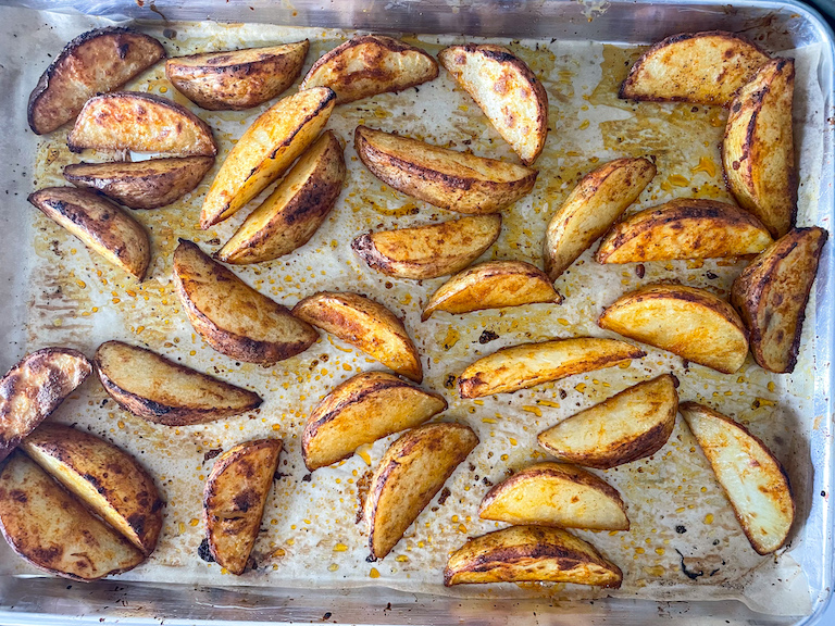 Roasted potato wedges on a tray