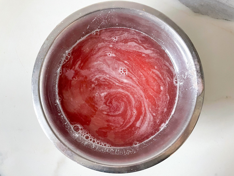 Pink rhubarb simple syrup in a bowl
