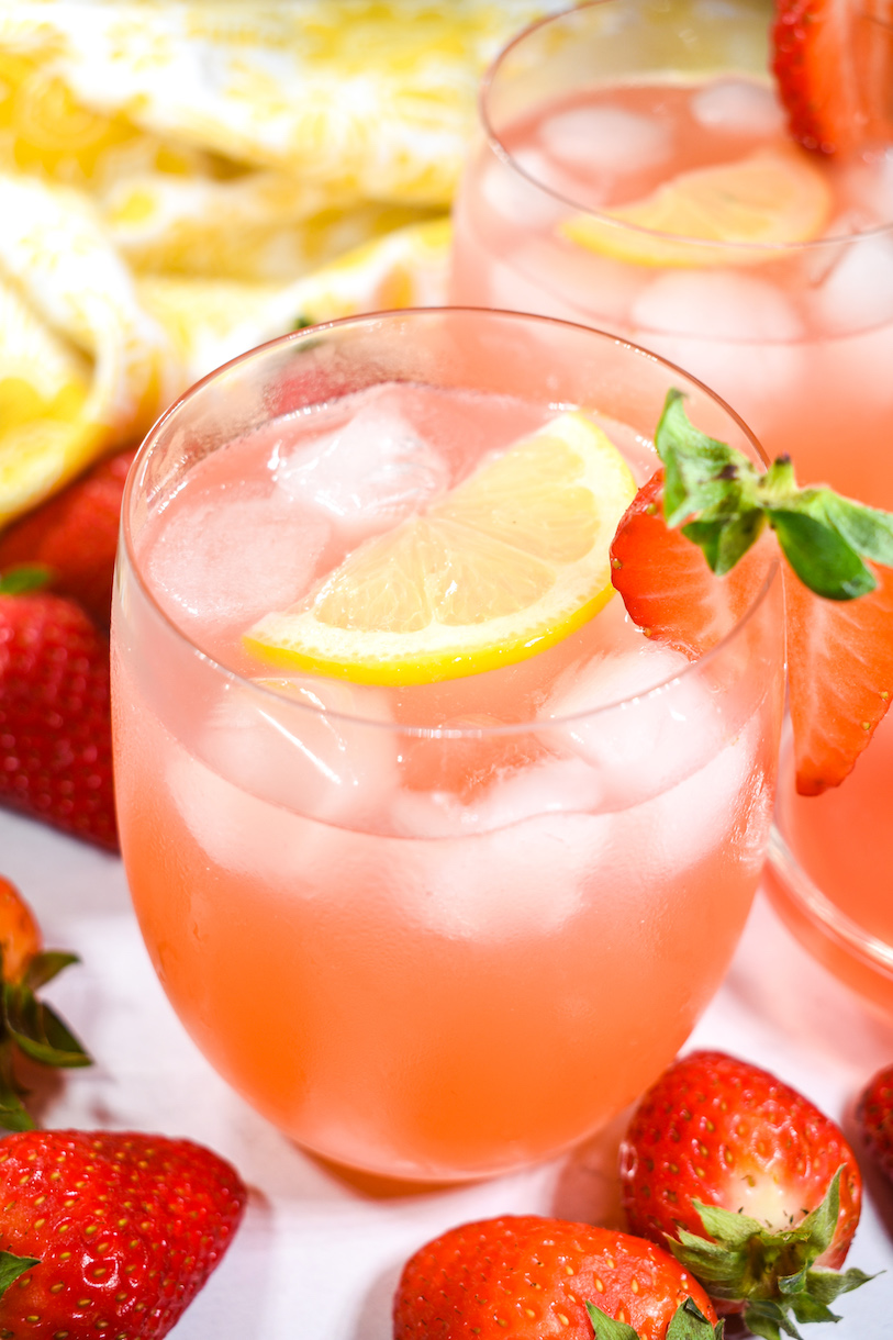 Rhubarb and strawberry lemonade in a glass with ice and fresh lemon slice