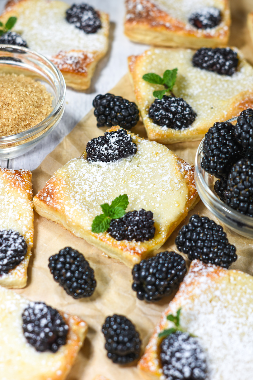 Blackberry pastries, dish of Demerara sugar, and dish of fresh berries