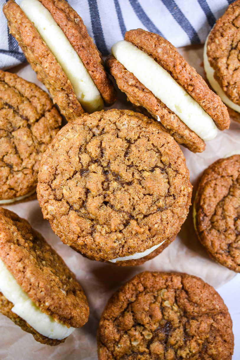 Homemade oatmeal cream pies arranged on a sheet of parchment
