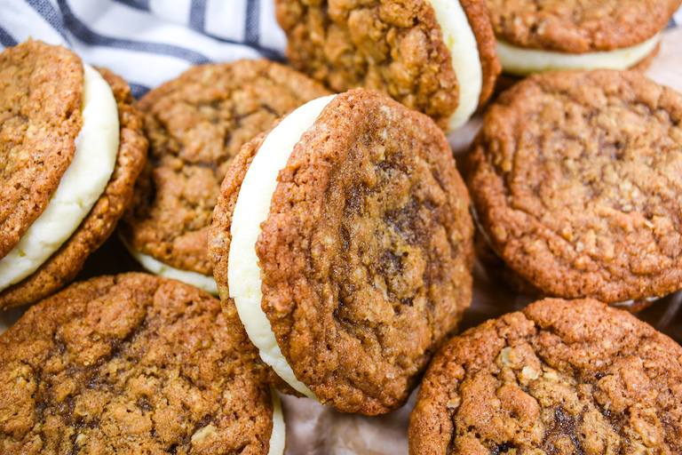 Oatmeal cream pies arranged on a sheet of brown parchment