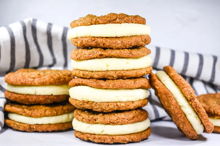 A stack of oatmeal cream pies and a striped tea towel