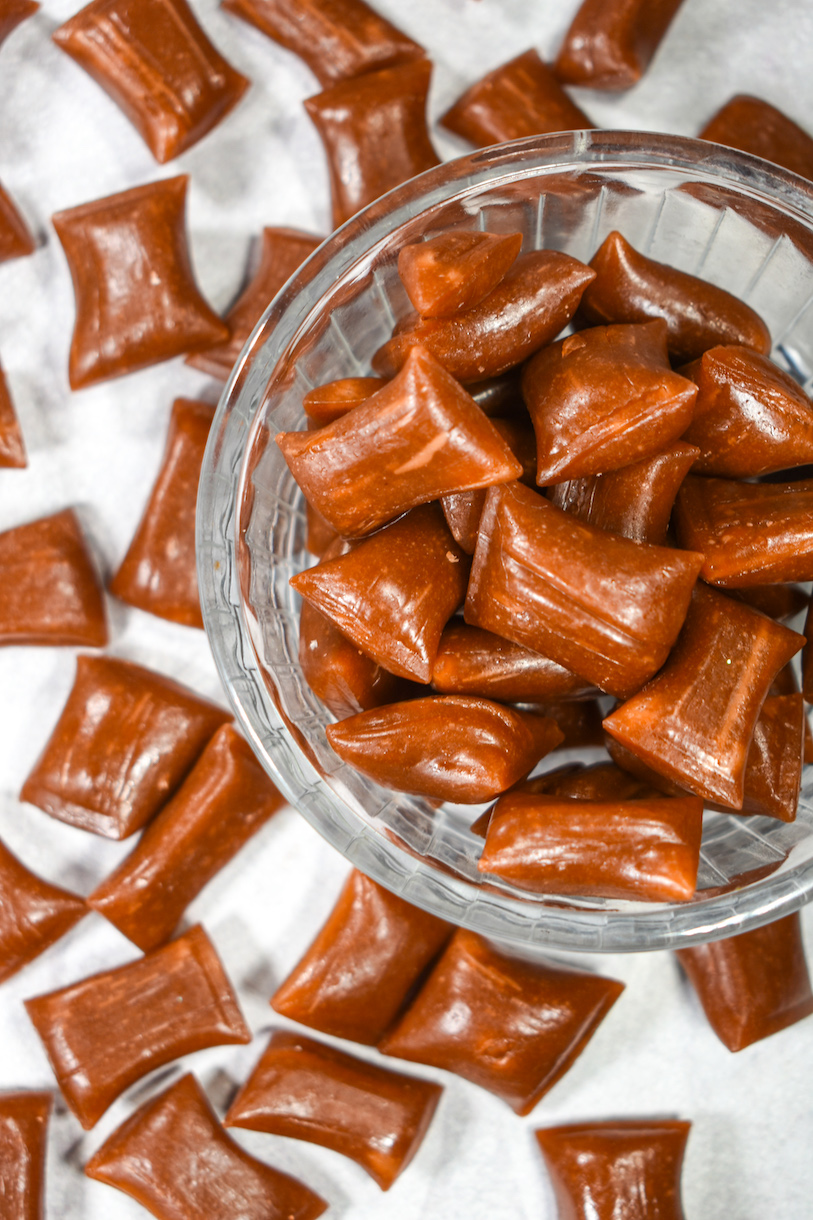 brown root beer candy pieces in a glass dish