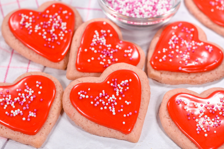 Valentine sugar cookies with red icing and sprinkles
