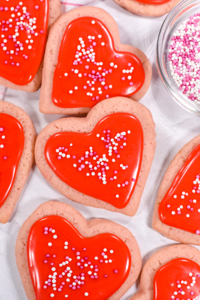 pink and red heart cookies arranged on a white surface