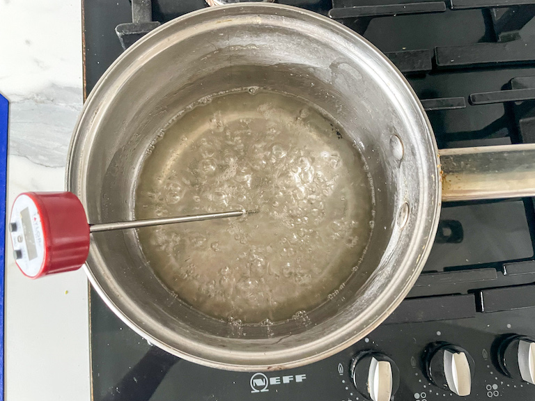 Boiling sugar in a saucepan with a thermometer