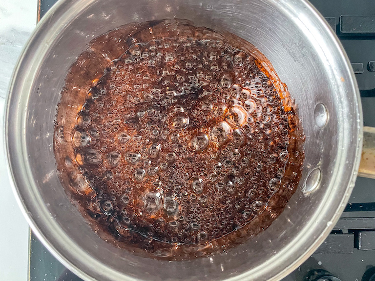 Boiling sugar tinted with root beer flavoring and brown color