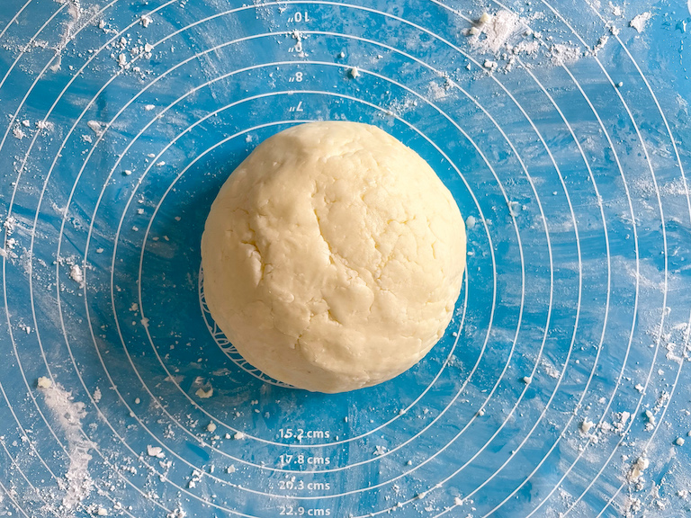 Ball of butter mint dough on a rolling mat