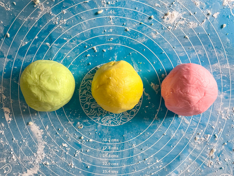 Green, yellow, and pink butter mint dough rolled into balls