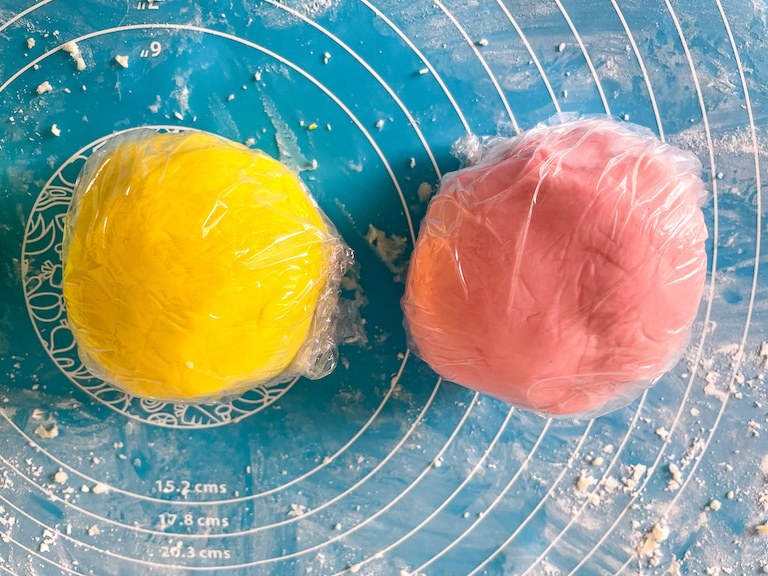 Balls of yellow and pink butter mint dough