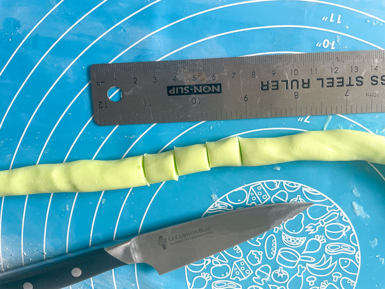 Butter mint dough in a rope, along with a ruler and a paring knife